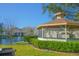 Community lakeside gazebo surrounded by a well-maintained lawn and lush landscaping near a lake at 3367 Crystal E Ct # F, Palm Harbor, FL 34685