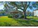 Community gazebo set in a grassy area with mature landscaping and surrounding residential buildings at 3367 Crystal E Ct # F, Palm Harbor, FL 34685