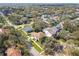 Aerial view of a home with a well-manicured lawn and mature trees in a quiet residential area at 3900 W Platt St, Tampa, FL 33609