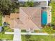 A bird's-eye view of a home with a private pool and patio area, surrounded by lush landscaping at 3900 W Platt St, Tampa, FL 33609