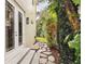 Charming backyard patio with stone pathway, landscaped with lush greenery creating a serene outdoor space at 3900 W Platt St, Tampa, FL 33609