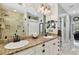 Elegant bathroom with double sinks, granite counters, and a tiled shower at 3900 W Platt St, Tampa, FL 33609