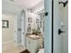 Bright bathroom with granite counters, a single sink, and a walk-in shower with dark bronze shower fixtures at 3900 W Platt St, Tampa, FL 33609