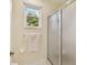 Bright bathroom with window, shower, and towel rack at 3900 W Platt St, Tampa, FL 33609