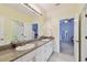 Spacious bathroom featuring double sinks, granite countertops, and a large vanity mirror at 3900 W Platt St, Tampa, FL 33609