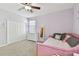 Comfortable bedroom has an airy feel, with light purple walls, a ceiling fan, and a large closet at 3900 W Platt St, Tampa, FL 33609