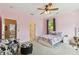 This bedroom has a ceiling fan, a playful chair, and natural light through a large window at 3900 W Platt St, Tampa, FL 33609