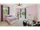 Bright bedroom has a large window, ceiling fan, and unique curtains that add a decorative touch at 3900 W Platt St, Tampa, FL 33609