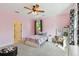 Bedroom featuring natural light, ceiling fan, and stylish curtains, desk, and a playful chair at 3900 W Platt St, Tampa, FL 33609