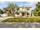 Charming two-story home with a well-manicured front lawn, inviting front porch, and a two car garage at 3900 W Platt St, Tampa, FL 33609