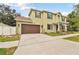 Spacious home with a two-car garage and well-kept lawn, offering great curb appeal at 3900 W Platt St, Tampa, FL 33609