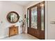 Elegant foyer featuring a stunning stained-glass front door, and a charming decorative mirror at 3900 W Platt St, Tampa, FL 33609