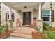 Elegant front entrance featuring a beautifully detailed wood door, classic columns, and brick steps at 3900 W Platt St, Tampa, FL 33609