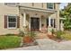 Inviting front porch with classic columns, brick steps, and beautifully landscaped garden beds at 3900 W Platt St, Tampa, FL 33609