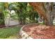 Front yard landscaping with lush plants and brick border at property with address marker at 3900 W Platt St, Tampa, FL 33609