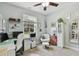 Bright home office featuring a ceiling fan, modern desk, and ample natural light streaming through a window at 3900 W Platt St, Tampa, FL 33609