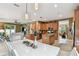 Bright and airy kitchen with wood cabinets, granite countertops and a white dining table and chairs at 3900 W Platt St, Tampa, FL 33609