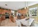 Eat-in kitchen with wood cabinets, granite countertops, stainless steel appliances and a white dining table at 3900 W Platt St, Tampa, FL 33609