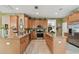 Kitchen area showcases granite countertops, wood cabinets, stainless appliances, and a large center island at 3900 W Platt St, Tampa, FL 33609