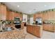 Kitchen area features granite counters, wood cabinets, stainless appliances and a large center island at 3900 W Platt St, Tampa, FL 33609