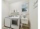 Laundry room with front loading washer and dryer and sink at 3900 W Platt St, Tampa, FL 33609