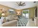 Comfortable living room with a large ceiling fan, sliding glass doors, and backyard views at 3900 W Platt St, Tampa, FL 33609