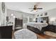 Main bedroom showcasing a large bed, hardwood floors, and a ceiling fan at 3900 W Platt St, Tampa, FL 33609
