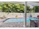 Private backyard pool area featuring a serene swimming pool and a spacious brick-paved deck at 3900 W Platt St, Tampa, FL 33609