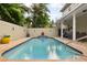 Private backyard pool with inviting lounge area, creating a perfect outdoor retreat for relaxation and enjoyment at 3900 W Platt St, Tampa, FL 33609