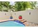 Beautiful pool featuring a charming waterfall, surrounded by lush landscaping for a serene backyard oasis at 3900 W Platt St, Tampa, FL 33609