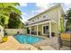 Inviting outdoor pool area with comfortable seating, patio space, and lush landscaping at 3900 W Platt St, Tampa, FL 33609