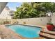 Inviting outdoor pool area with comfortable seating, patio space, and lush landscaping at 3900 W Platt St, Tampa, FL 33609