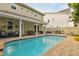 Inviting outdoor pool area with comfortable seating, patio space, and lush landscaping at 3900 W Platt St, Tampa, FL 33609