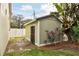 Backyard shed featuring a well-maintained exterior, enhanced by attractive landscaping and a neatly manicured lawn at 3900 W Platt St, Tampa, FL 33609