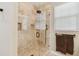 Luxurious shower features a glass door, tiled walls, rainfall showerhead, and a convenient hand-held sprayer at 3900 W Platt St, Tampa, FL 33609