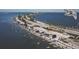 Aerial view of the beach with people gathering with various watercraft along the stunning coastline at 417 Tennessee Ave, Crystal Beach, FL 34681