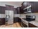 Modern kitchen featuring stainless steel appliances and dark wood cabinetry at 417 Tennessee Ave, Crystal Beach, FL 34681