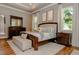 Well-lit main bedroom with wood floors, neutral tones, and elegant furnishings at 417 Tennessee Ave, Crystal Beach, FL 34681