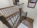 Wooden staircase with black iron railings, natural light from nearby windows at 417 Tennessee Ave, Crystal Beach, FL 34681