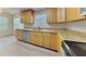 Well-lit kitchen with stainless steel appliances, wooden cabinets, and bright countertops at 4140 Brentwood Park Cir, Tampa, FL 33624