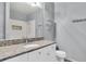 A renovated bathroom features a granite countertop, white cabinets, and a tiled shower at 4221 W Spruce St # 1407, Tampa, FL 33607
