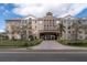 A well-maintained multi-story apartment building with stone facade and covered entrance at 4221 W Spruce St # 1407, Tampa, FL 33607