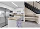 Modern kitchen featuring white cabinetry, stainless steel appliances, and a stylish center island at 4221 W Spruce St # 1407, Tampa, FL 33607