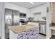 Modern kitchen with stainless steel appliances, granite countertop, white cabinets, and a stylish island at 4221 W Spruce St # 1407, Tampa, FL 33607