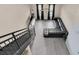 Spacious living room featuring a modern black sofa, staircase, and sleek gray flooring at 4221 W Spruce St # 1407, Tampa, FL 33607