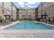 Resort-style swimming pool surrounded by a brick patio and multi-story building, perfect for relaxation and recreation at 4221 W Spruce St # 1407, Tampa, FL 33607