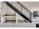 A modern staircase with black railings adjacent to a desk space with a granite countertop at 4221 W Spruce St # 1407, Tampa, FL 33607