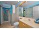 Unique bathroom featuring vibrant wall art, a glass shower enclosure, and modern fixtures at 4677 Aylesford Dr, Palm Harbor, FL 34685