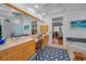 Nautical themed bathroom featuring dual sinks, an adjacent tub, and wood cabinetry at 4677 Aylesford Dr, Palm Harbor, FL 34685