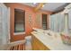 Bathroom with earth tone walls, large mirror, and a patterned rug at 4677 Aylesford Dr, Palm Harbor, FL 34685